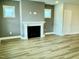 Living room featuring a fireplace and light colored wood flooring at 1915 Plott Balsam Dr, Wendell, NC 27591