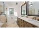 Bathroom featuring double sinks, travertine tile and glass enclosed shower at 2008 Corberrie Ln, Raleigh, NC 27613