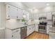 Updated kitchen features white cabinets, stainless steel appliances, and granite countertops at 2008 Corberrie Ln, Raleigh, NC 27613