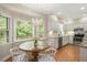Bright kitchen features white cabinetry, granite countertops, stainless steel appliances and adjacent breakfast nook at 2008 Corberrie Ln, Raleigh, NC 27613