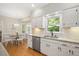 Bright kitchen features white cabinetry, stainless steel appliances and adjacent breakfast nook at 2008 Corberrie Ln, Raleigh, NC 27613