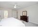 Bright main bedroom featuring a ceiling fan, neutral walls, and ensuite bathroom at 2008 Corberrie Ln, Raleigh, NC 27613
