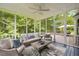 Relaxing screened-in porch features wicker furniture and view of wooded backyard at 2008 Corberrie Ln, Raleigh, NC 27613