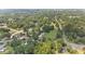 A high altitude view showing surrounding properties, homes and wooded areas, and a distant view of the city at 2021 W Front St, Burlington, NC 27215