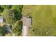 An aerial view of a well maintained home showing the roof, driveway, lawn, and surrounding trees and property line at 2021 W Front St, Burlington, NC 27215