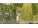 An aerial view of a well maintained home showing the roof, driveway, lawn, and surrounding trees at 2021 W Front St, Burlington, NC 27215