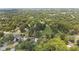 A high altitude view showing surrounding properties, homes and wooded areas, and a distant view of the city at 2021 W Front St, Burlington, NC 27215
