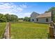 Picturesque backyard with a sprawling green lawn and a rustic wooden fence, ideal for relaxation at 2021 W Front St, Burlington, NC 27215