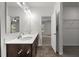 Bathroom with double vanity, hardwood floors, and natural light at 2021 W Front St, Burlington, NC 27215