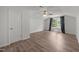 Bedroom featuring wood-look floors, a ceiling fan, and a window with curtains at 2021 W Front St, Burlington, NC 27215
