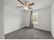 Cozy carpeted bedroom with a ceiling fan and window views at 2021 W Front St, Burlington, NC 27215