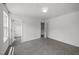 A bright bedroom with plush carpet and a view into a walk in closet at 2021 W Front St, Burlington, NC 27215