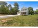 Charming two-story home featuring a brick and siding facade, attached garage, and a well-maintained front yard at 2021 W Front St, Burlington, NC 27215