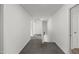 Hallway with neutral walls and carpet, offering seamless transition between spaces at 2021 W Front St, Burlington, NC 27215