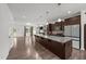 Open kitchen with large island, modern appliances, granite countertops, and wood cabinets flows into living area at 2021 W Front St, Burlington, NC 27215