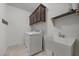 A laundry room with a white sink and a full sized washer and dryer set at 2021 W Front St, Burlington, NC 27215