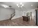 Bright living room featuring hardwood floors, chandelier, stairs, and a granite island with pendant lighting at 2021 W Front St, Burlington, NC 27215