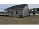 View of the backyard featuring a house with gray siding and a dark roof at 2036 Abbeyhill Dr # 99, Raleigh, NC 27610