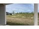 View of the backyard featuring an unfinished lawn with other houses in the distance at 2036 Abbeyhill Dr # 99, Raleigh, NC 27610