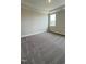 Spacious bedroom with plush carpeting, tray ceiling, and natural light from a large window at 2036 Abbeyhill Dr # 99, Raleigh, NC 27610