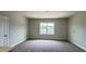 Comfortable bedroom with carpet, neutral walls, and a view of the neighborhood through the window at 2036 Abbeyhill Dr # 99, Raleigh, NC 27610