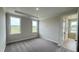 Bright bedroom featuring tray ceiling, carpet, and large windows at 2036 Abbeyhill Dr # 99, Raleigh, NC 27610