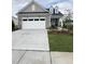 Charming single-Gathering home featuring stone accents, a two-car garage, and well-maintained landscaping at 2036 Abbeyhill Dr # 99, Raleigh, NC 27610