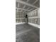 Unfinished garage with exposed walls, and a hot water heater at 2036 Abbeyhill Dr # 99, Raleigh, NC 27610