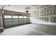 Unfinished two car garage with an automatic door opener and concrete flooring at 2036 Abbeyhill Dr # 99, Raleigh, NC 27610