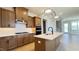 Modern kitchen with a central island, stainless steel appliances, and stylish light fixtures at 2036 Abbeyhill Dr # 99, Raleigh, NC 27610