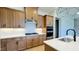 Bright kitchen featuring an island with a sink, custom cabinetry, and a gas cooktop at 2036 Abbeyhill Dr # 99, Raleigh, NC 27610