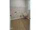 Functional laundry room with a utility sink, ample shelving, and wood-look flooring at 2036 Abbeyhill Dr # 99, Raleigh, NC 27610