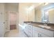 A bathroom featuring a double vanity, large mirror and attached storage closet at 21 Abingdon Farms Dr, Selma, NC 27576