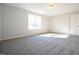 An empty bedroom featuring plush carpeting and lots of natural light at 21 Abingdon Farms Dr, Selma, NC 27576