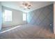 An empty bedroom shows the geometric accent wall, plush carpeting, and natural light at 21 Abingdon Farms Dr, Selma, NC 27576