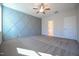 An empty bedroom featuring a geometric accent wall and plush carpeting at 21 Abingdon Farms Dr, Selma, NC 27576