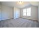 Comfortable bedroom featuring a window, neutral walls, and plush carpeting at 21 Abingdon Farms Dr, Selma, NC 27576