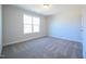 Cozy bedroom with natural light, showcasing neutral walls and plush carpeting at 21 Abingdon Farms Dr, Selma, NC 27576