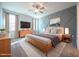 A staged bedroom with a geometric accent wall, wood furniture and neutral tones at 21 Abingdon Farms Dr, Selma, NC 27576