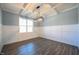 Dining room featuring hardwood floors, modern chandelier and wainscotting with a large window at 21 Abingdon Farms Dr, Selma, NC 27576