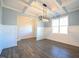 Dining room featuring hardwood floors, modern chandelier and wainscotting with a large window at 21 Abingdon Farms Dr, Selma, NC 27576