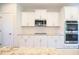 Gourmet kitchen featuring white cabinets, stainless steel appliances, and granite countertops at 21 Abingdon Farms Dr, Selma, NC 27576