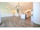 Open-concept living space with hardwood floors, staircase, and a kitchen island at 21 Abingdon Farms Dr, Selma, NC 27576