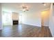 Open-concept living room featuring hardwood floors and a fireplace at 21 Abingdon Farms Dr, Selma, NC 27576