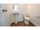 This powder room features shiplap walls, a pedestal sink, and wood-look flooring at 21 Abingdon Farms Dr, Selma, NC 27576