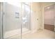 A tiled shower with glass door, built-in shelves, and tiled flooring at 21 Abingdon Farms Dr, Selma, NC 27576