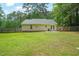 Well-maintained backyard with a full, green lawn, wooden privacy fence, and mature trees at 2116 Sterling Creek Ln, Franklinton, NC 27525
