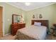 Bedroom with ceiling fan, a bed with a decorative bedspread and a wood dresser with a mirror at 2116 Sterling Creek Ln, Franklinton, NC 27525