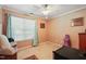 Bedroom with a window, a ceiling fan, neutral colored walls, and a comfortable looking chair at 2116 Sterling Creek Ln, Franklinton, NC 27525
