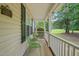 Inviting front porch with green metal chairs, ideal for relaxing outdoors at 2116 Sterling Creek Ln, Franklinton, NC 27525